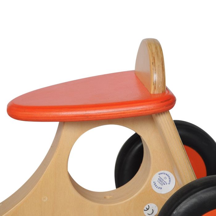 Buy a wooden cargo balance bike with orange accents now Babboe